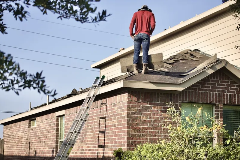 Professional roofer working on a residential roof in Sumter